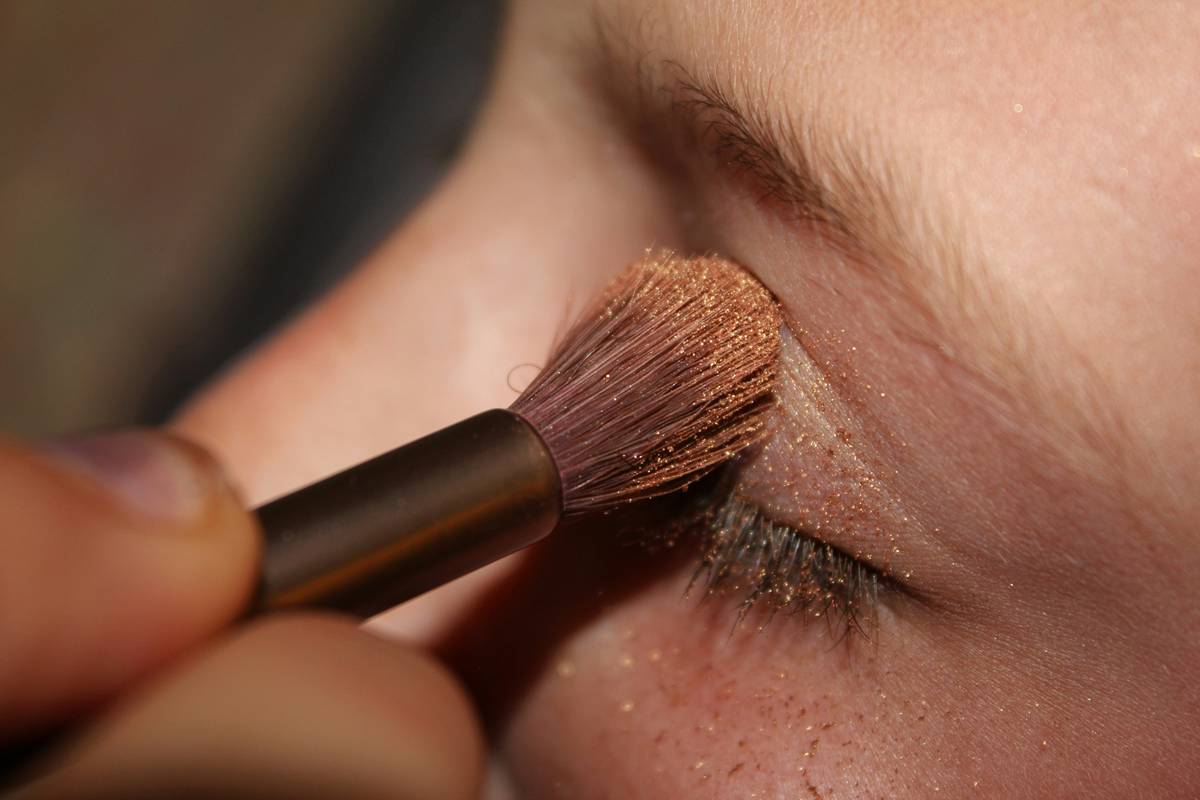 Bridal model with flawless formal event makeup under soft lighting